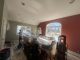 Professional painters applying fresh wall paint in a small living room during a home interior makeover with modern color ideas.