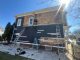 Professional crew removing old exterior paint from wood siding before repainting a two-story home by Rodrigo's Painting.