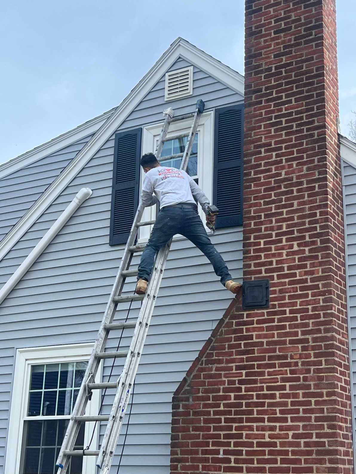 Window trim and shutter painting on a Lynn, MA home