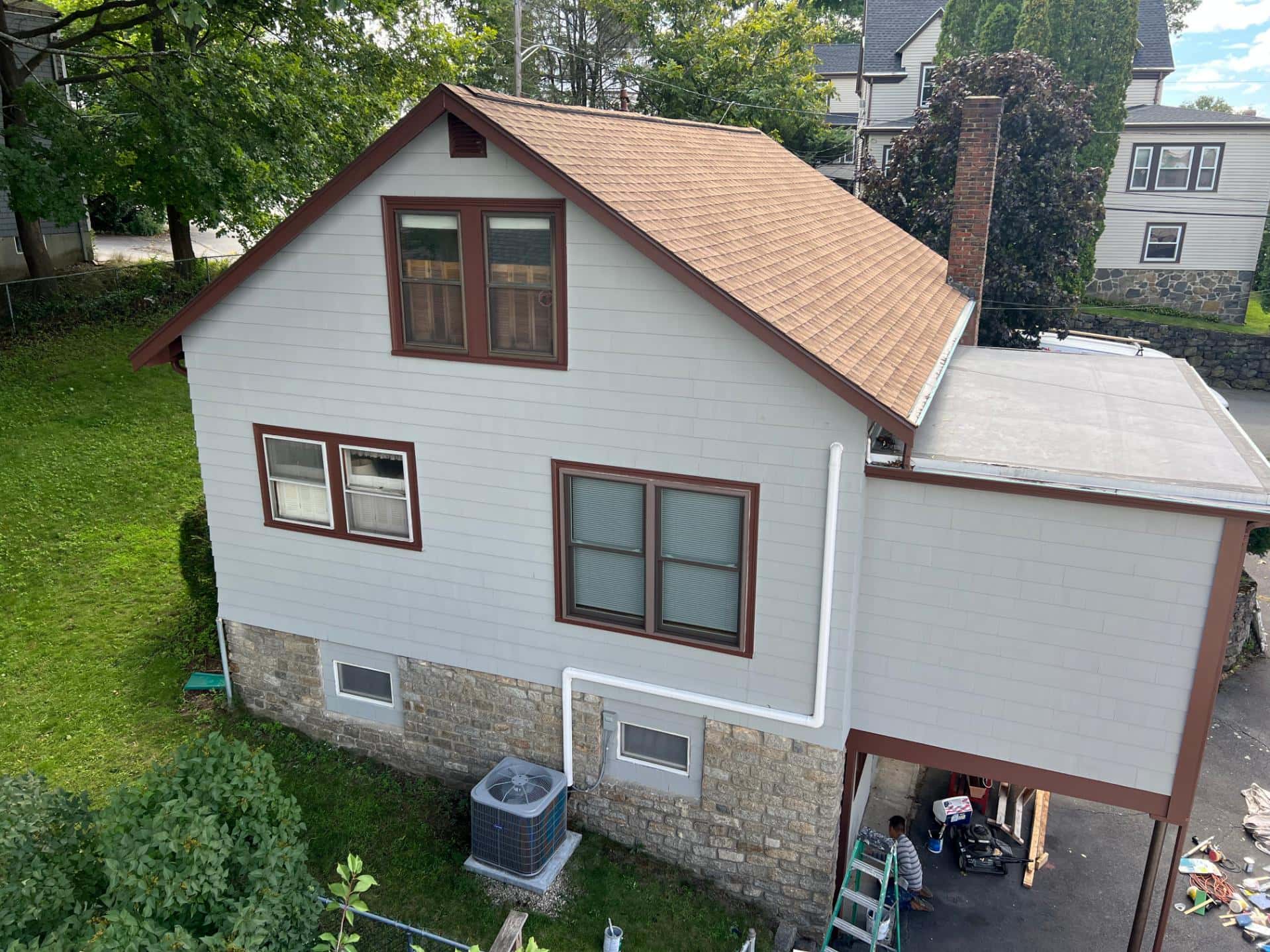 Exterior paint colors for white siding with contrasting brown trim on a residential home