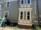 Exterior house painting of gray siding with white architectural window trim