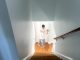 Professional stairway painting of light-colored walls, trim, and a white door in a residential home